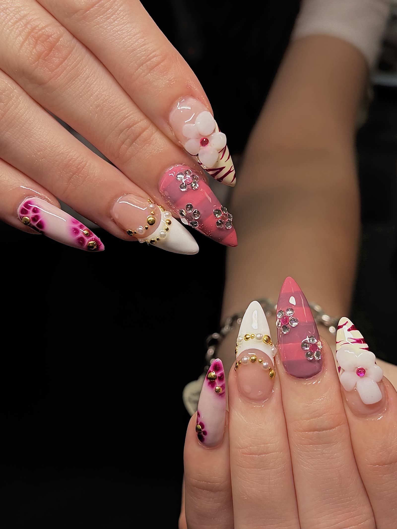 Stiletto set mixing pink plaid, rhinestone flowers, a pearl-beaded cuticle line and a 3D white flower