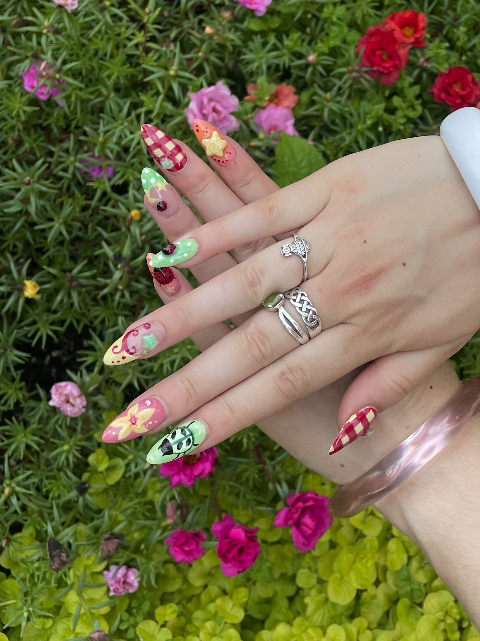 The novelty beetle-and-gingham set photographed over a bed of pink and red flowers